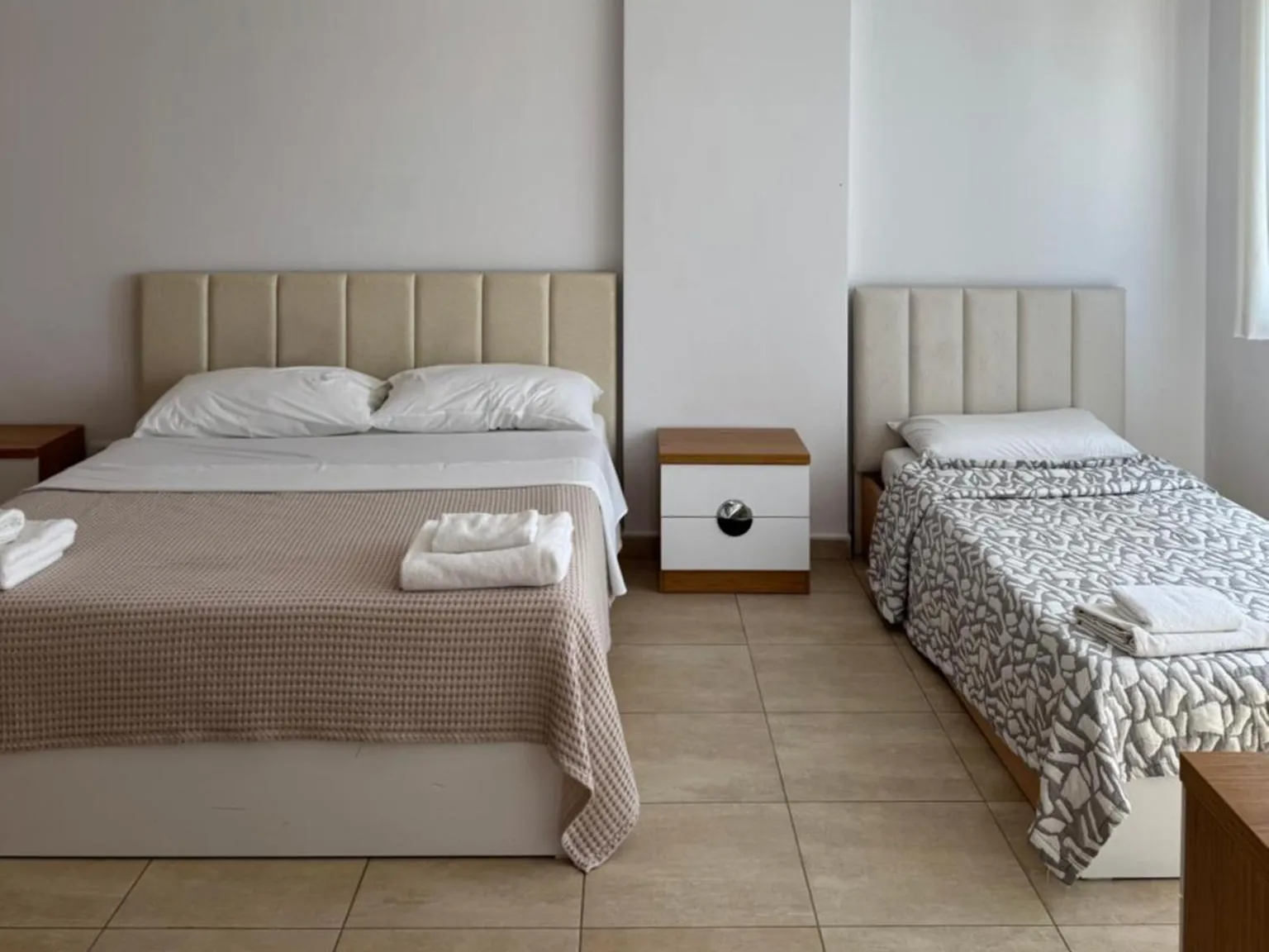 Triple room with a double bed and a single bed at Casa Italia Apartments, Tirana